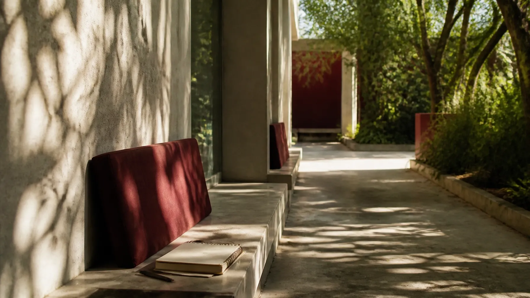 Notebook resting beside a shaded urban path in a quiet editorial scene after class